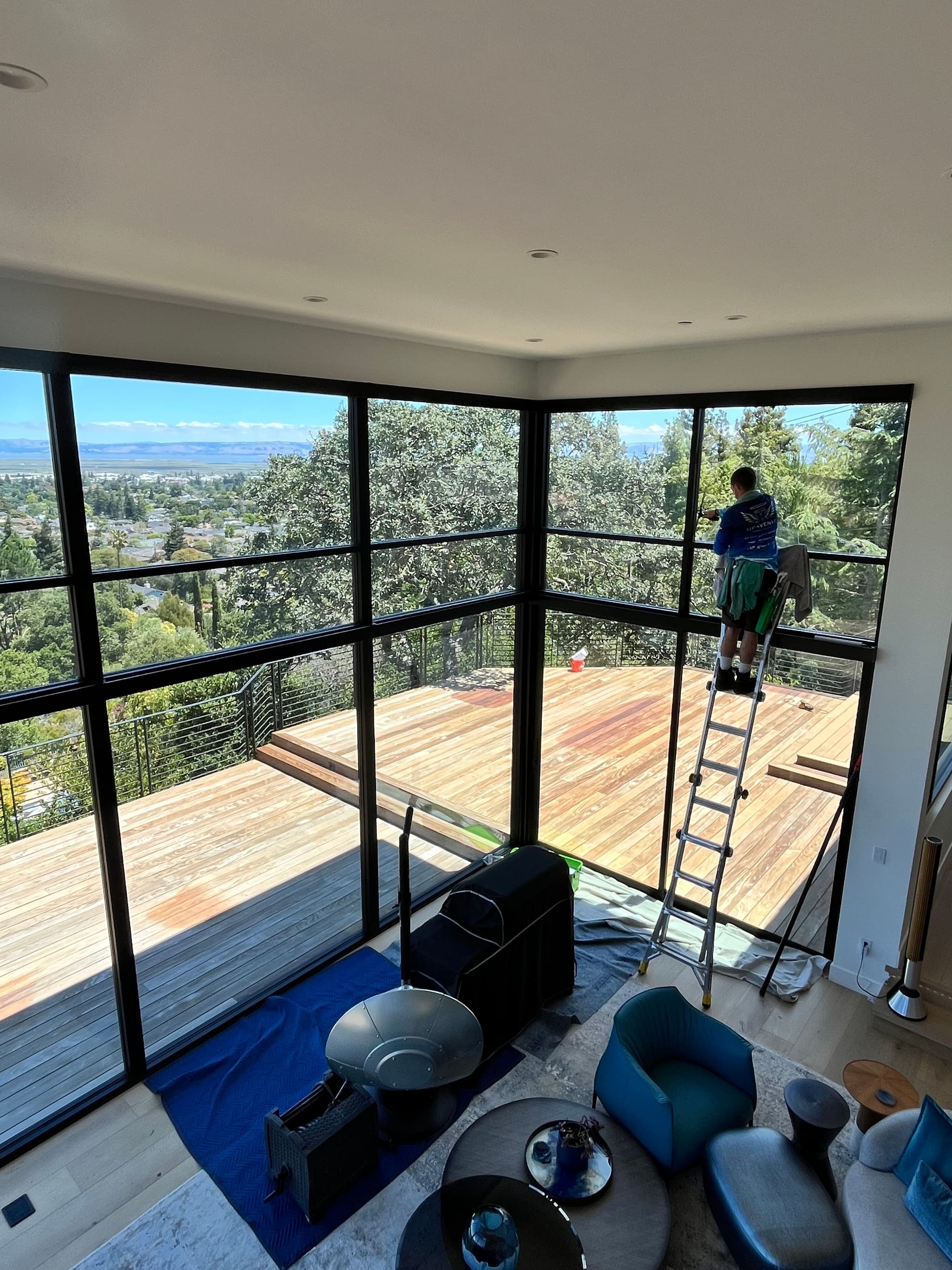 Interior view through large clean picture windows out to trees