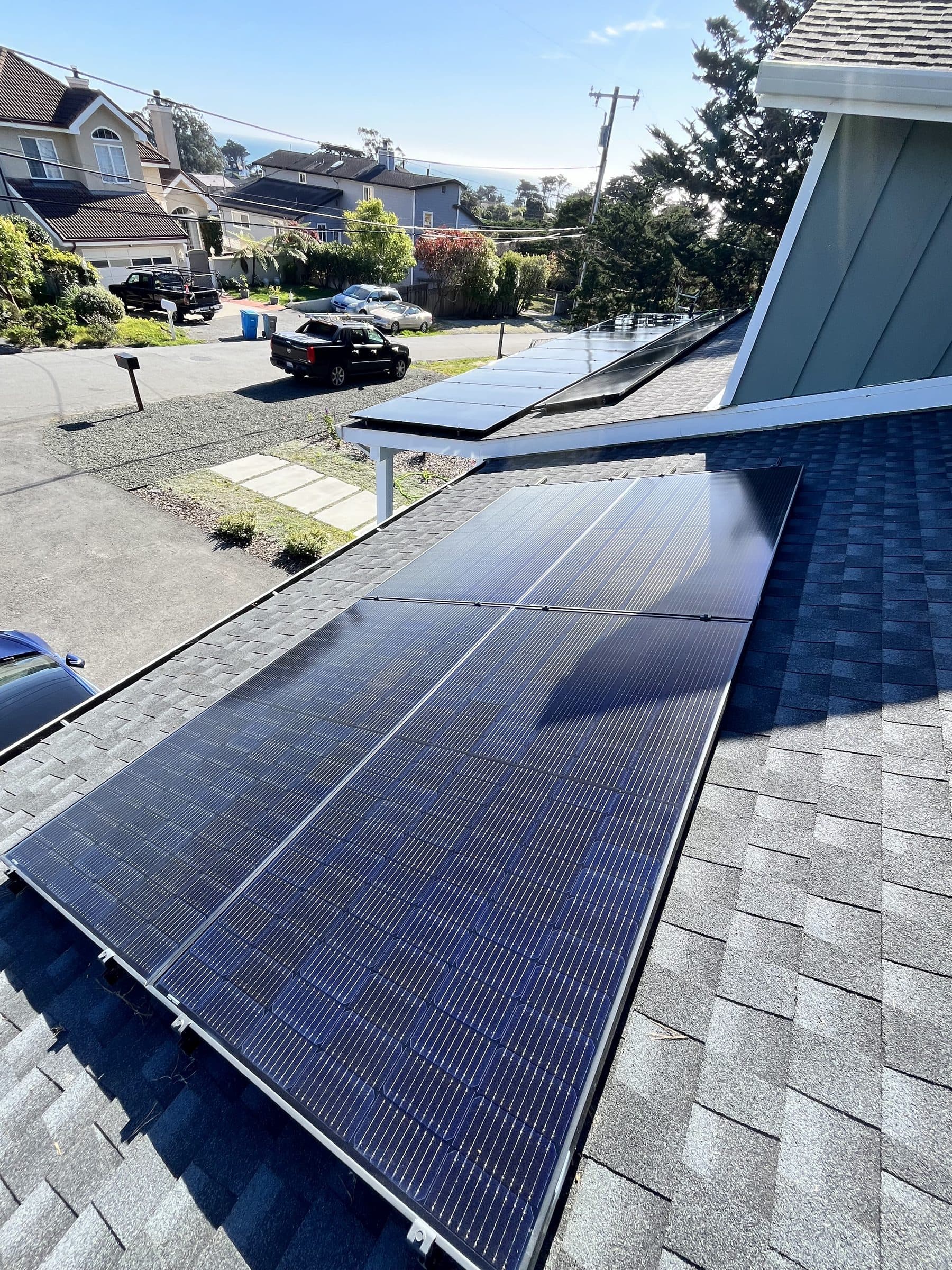 Clean rooftop solar panels on a home above a residential street