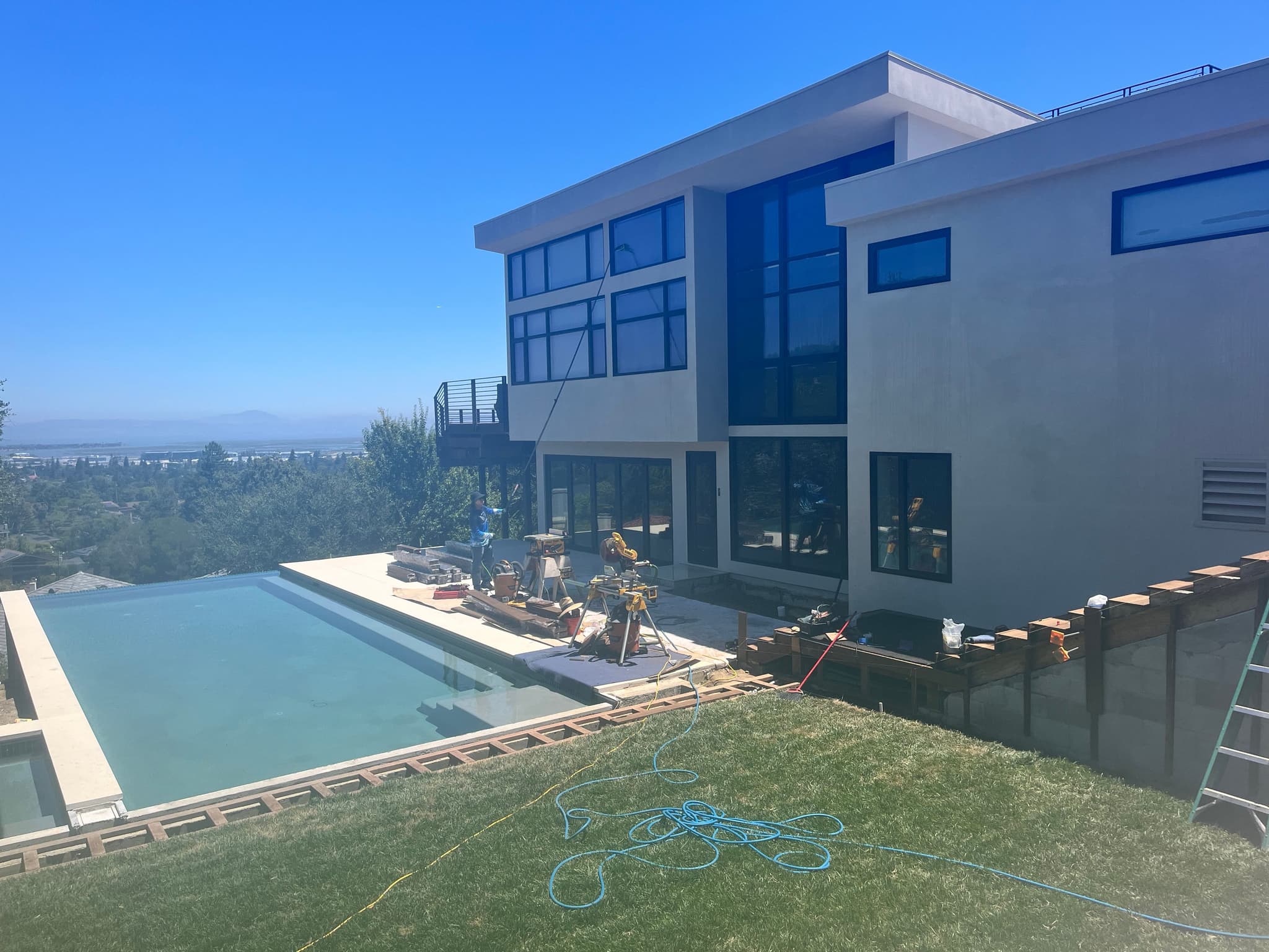 Modern estate exterior with a pool and large glazed openings