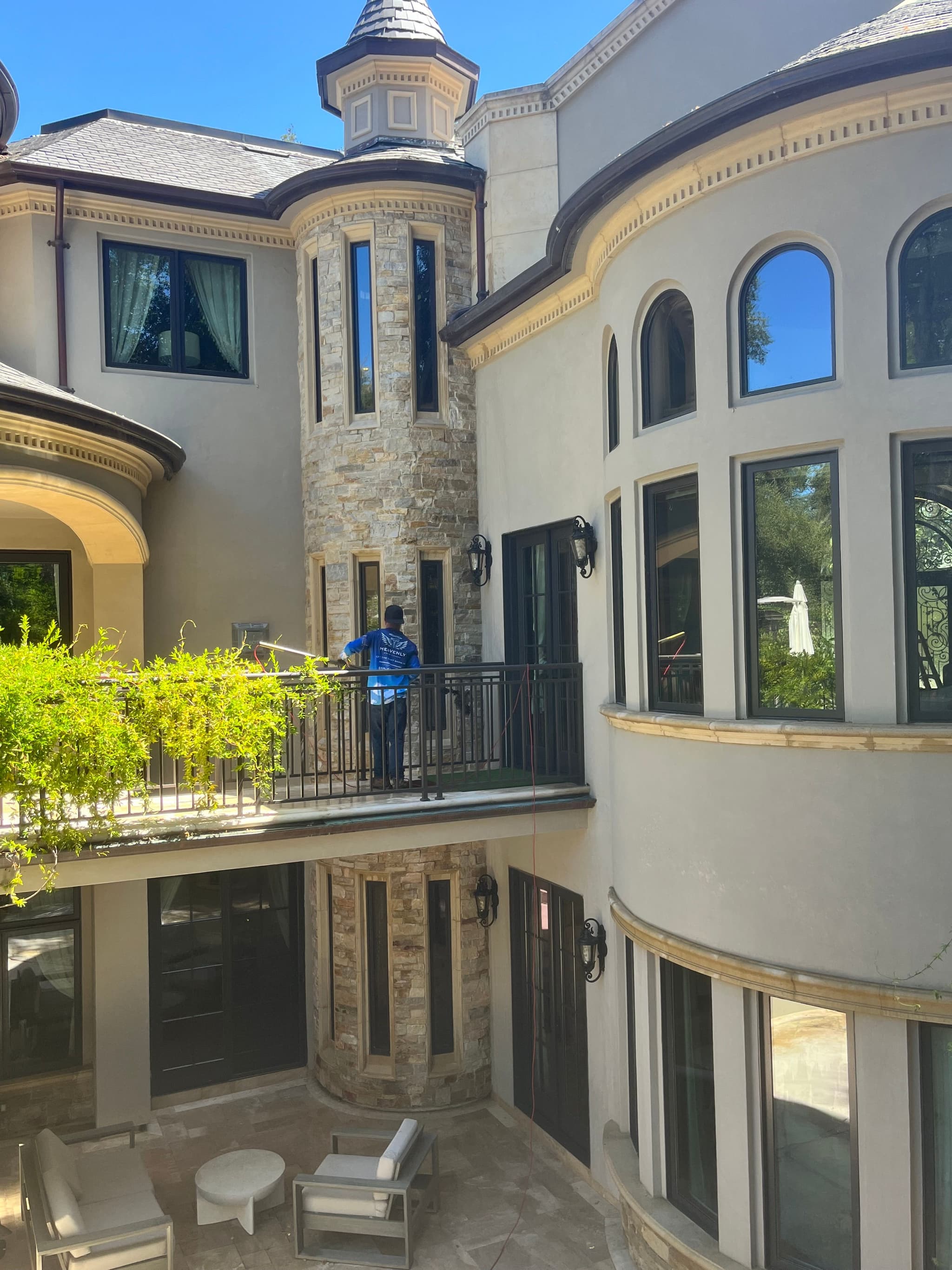 Spanish revival home with an arched entry and period window openings